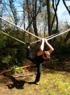 A person holding onto a rope

Description automatically generated