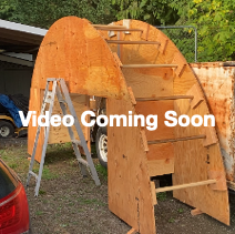 A wooden structure with ladders and a ladder next to a car

Description automatically generated