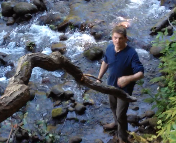 A person standing in a stream

Description automatically generated