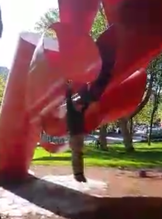 A person from a red object

Description automatically generated